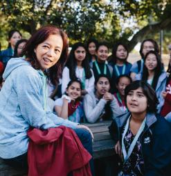 Professor Fei-Fei Li speaks to a group of young women during a research demonstration for Stanford AI4ALL.