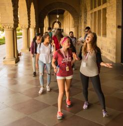 Participants walk through Memorial Quad Arches as they explore campus during a scavenger hunt.