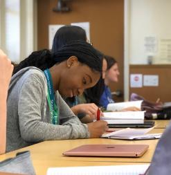 A student takes notes during a screenwriting course.